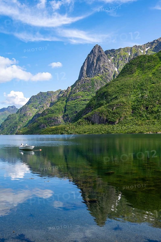 Small boats at the fjord Austnesfjorden, idyllic Norwegian fjord landscape, mountains reflected in the water, Sildpollen, Nordland, Norway
