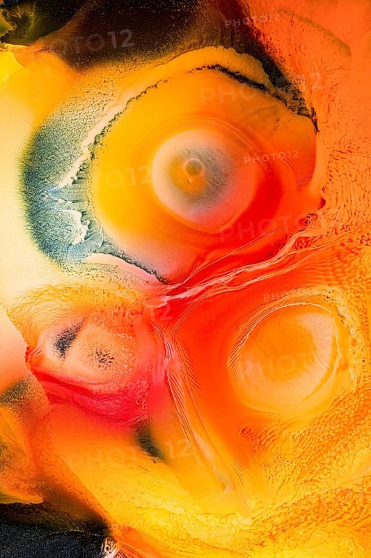 This abstract image features vibrant swirls of red, orange, and yellow hues, creating dynamic patterns and textures that evoke a sense of energy and movement in the galaxy