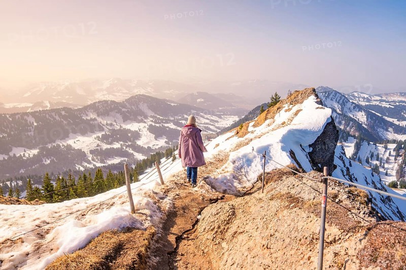 Person on a snowy mountain trail with sweeping views, Hochgrat Mountains, Allgäu Alps, Oberreute, Germany