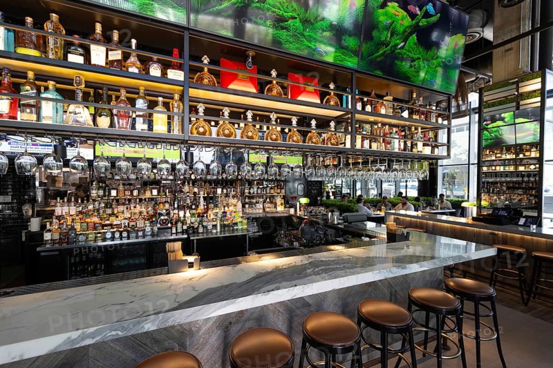 Fort Lauderdale restaurant bar with a variety of wine and liquor bottles and glasses on the shelves