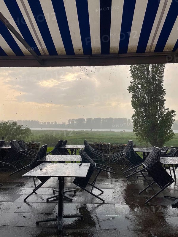 Thunderstorm and raindrops on a terrace of a restaurant on the Rhine in Düsseldorf, Germany