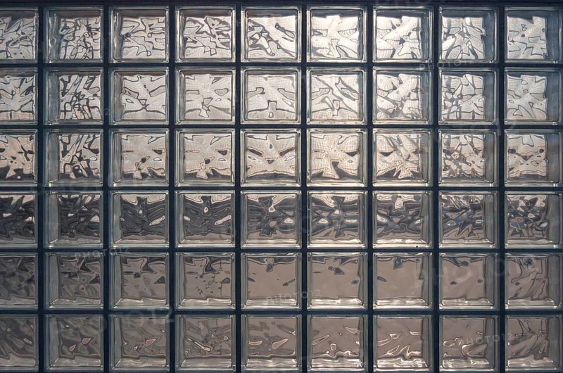 Aesthetic and modern design of textured glass block wall, capturing abstract patterns and light distortions. The photo was taken in Valdebebas, a major transport hub in Madrid