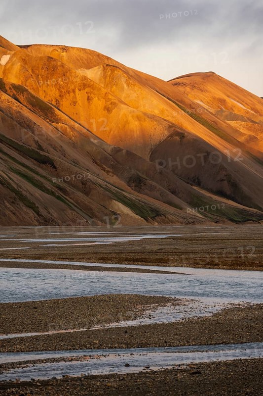 Rhyolite mountains and river Jökulgilskvísl, Landscape at Landmannalaugar, Dramatic volcanic landscape at sunset, Colourful erosion landscape with mountains, Landmannalaugar, Fjallabak Nature Reserve, Suðurland, Iceland