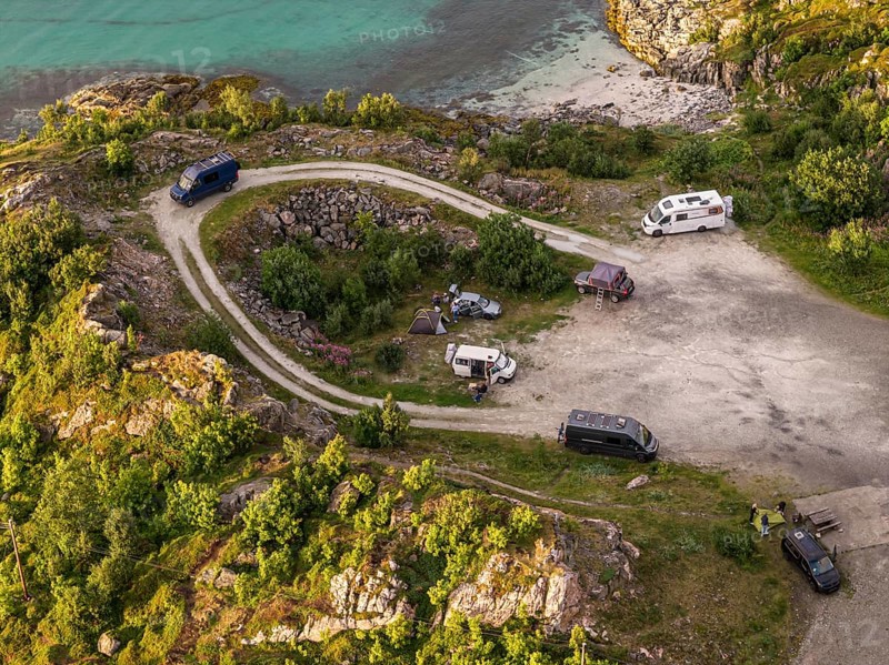 Rest area at Sommaroy Bridge, camper vans, sunset, aerial view, Norway