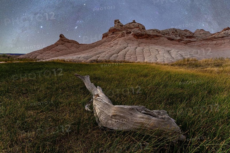 A serene spring night at Coyote Buttes in the Paria Canyon-Vermilion Cliffs Wilderness, Arizona, featuring a starry sky above the unique landscape