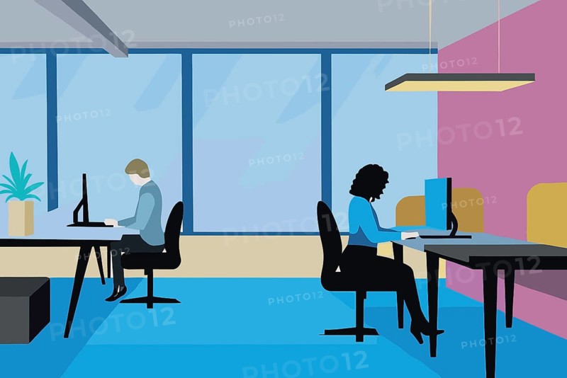 Two professionals are focused on their tasks in a contemporary office environment