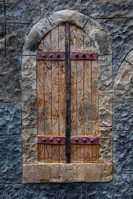 Stone wall with closed wooden window, Plakias, south coast, Crete, Greece