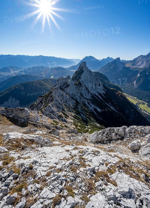 View at the summit of the Große Arnspitze, mountain panorama with Karwendel Mountains and Arnplattenspitze, sun star, autumnal mountain landscape, near Scharnitz, Bavaria, Germany