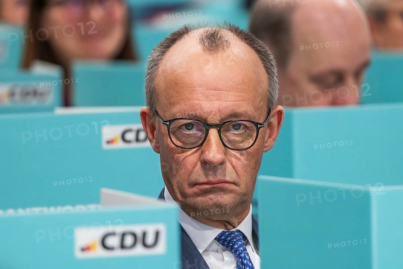 38th Federal Party Congress of the CDU of Germany in Stuttgart. Federal Chancellor Friedrich Merz has left the stage and podium and is sitting in the ranks of delegates from the state association of North Rhine-Westphalia during the election. Privacy when voting by secret ballot. Stuttgart, Baden-Württemberg, Germany