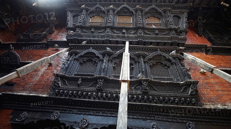 Detailed view of artfully carved facades, Kumari Ghar at Durbarsquare in Kathmandu with detailed historic building facades and secured from collapse with wooden supports after the earthquake, Kathmandu, Nepal