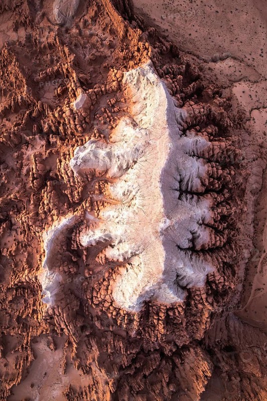 This stunning aerial image captures the intricate, textured sandstone formations of Goblin Valley State Park in Utah, showcasing nature's artistry with its varied hues and rugged landscape