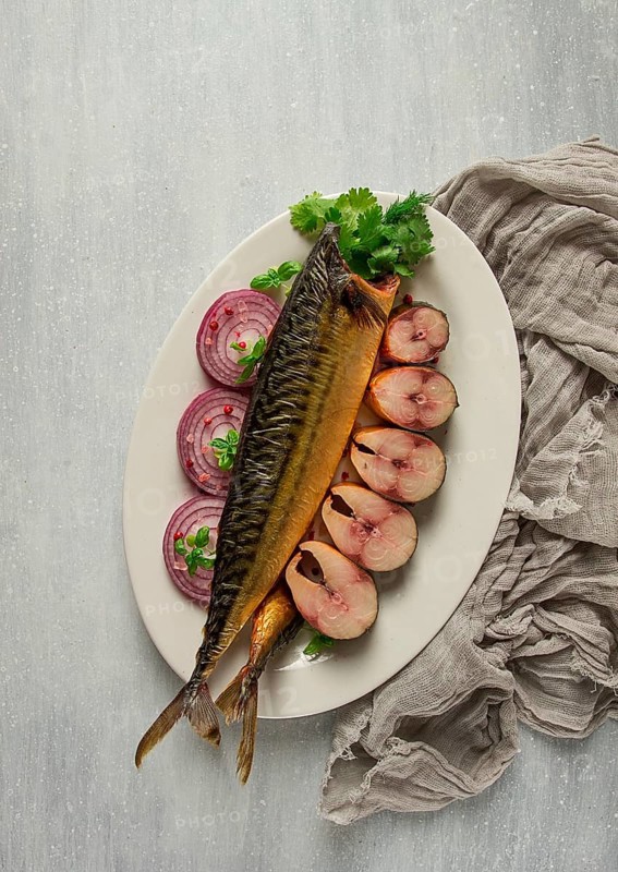 Smoked mackerel, top view, with spices, on a wooden table, no people, selective focus
