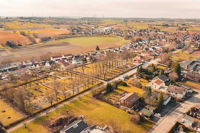 Nice view of a village with trees and fields, the cemetery is visible, Ötisheim, Enzkreis, Germany