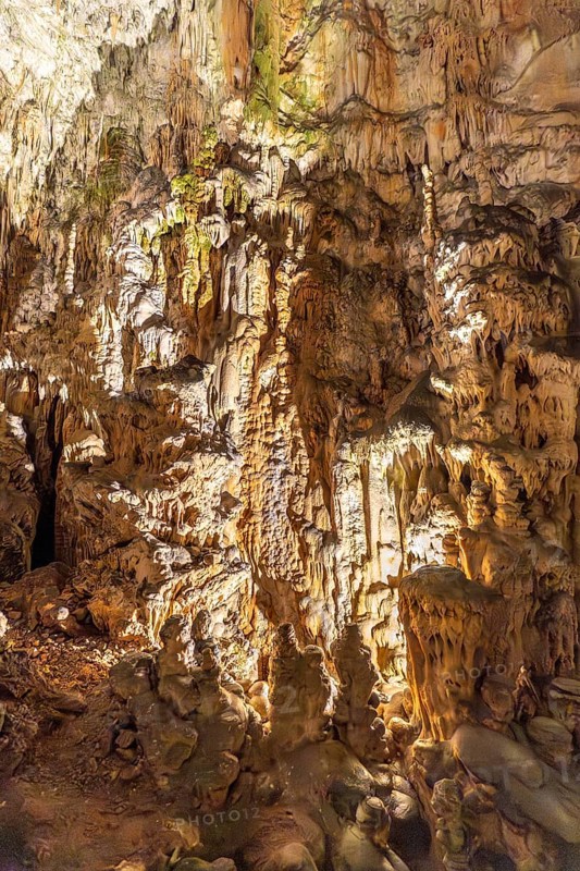 Breathtaking view of illuminated stalactites and stalagmites formations inside postojna cave, a famous tourist attraction in slovenia