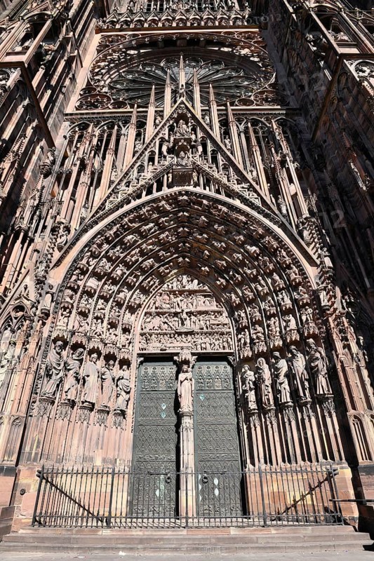 Strasbourg, France, September 2023: Gothic style entrance door with tympanum of west facade of famous Strasbourg Cathedral in France