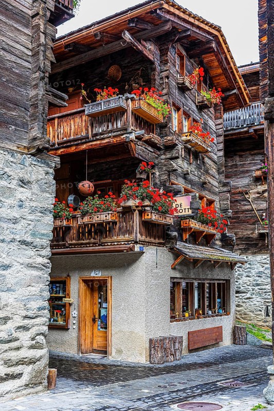 Old house decorated with flowers in the historic village centre, Grimentz, Val d'Anniviers, Valais Alps, Canton Valais, Switzerland