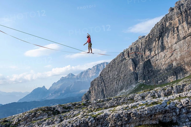 Slackliner in the mountains, mountain peaks of the Brenta Mountains, at Refugio Francis Fox Tuckett, Brenta, Brenta-Adamello Natural Park, Trentino, Italy