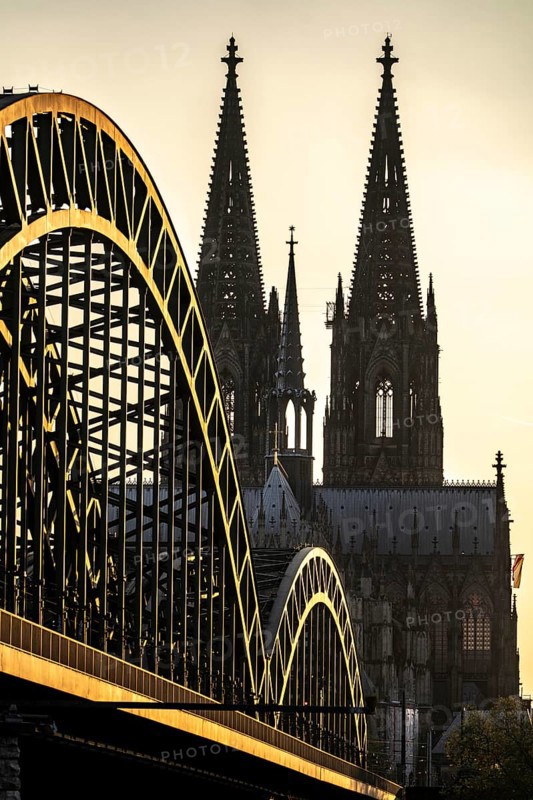 Silhouettes of the cathedral in late sunlight, view of Cologne Cathedral and the Hohenzollern railway bridge over the Rhine near Cologne, North Rhine-Westphalia, Germany