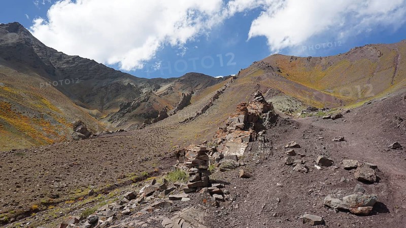 Rocky mountain landscape with rock formations under cloudy sky, trekking at Stok La Pass in Ladakh, Himalayas, India