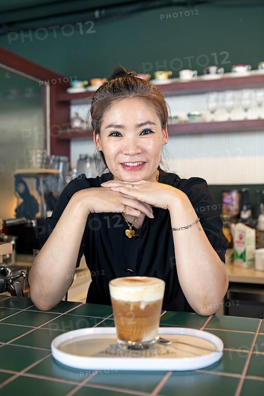 Korean woman, 47, in her café, Yeosu, Jeollanam-do Province, South Korea