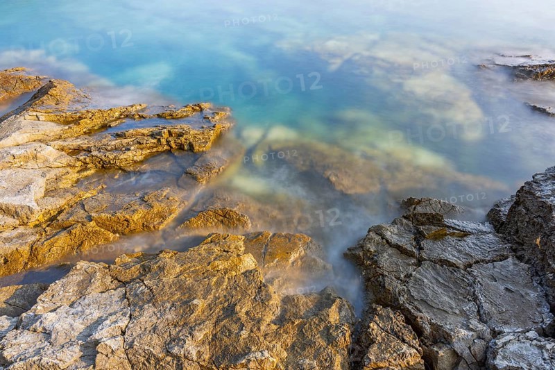 Crystal clear and turquoise water on the beach of Ustrine Bay on a sunny day on the island of Cres, long exposure, Croatia