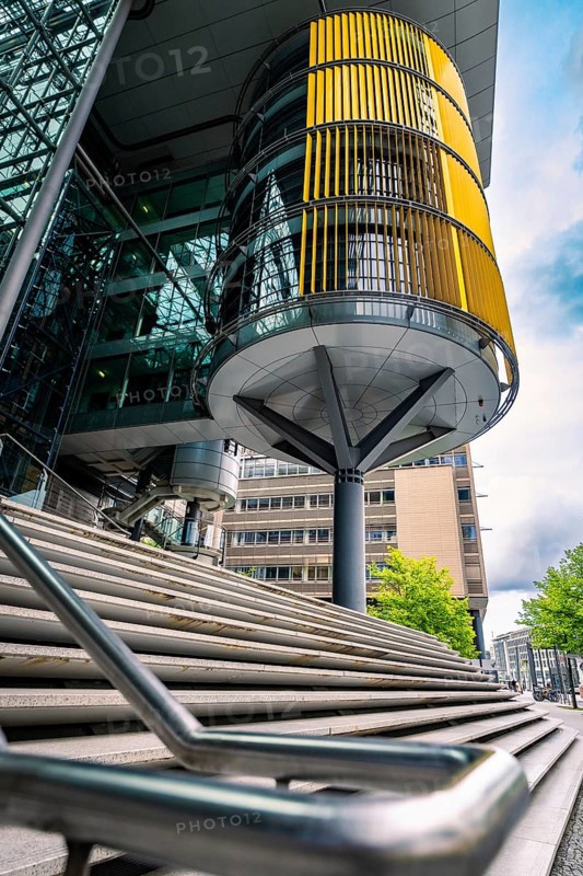 Modern building design with glass façade and yellow blinds in an urban environment, Berlin, Germany