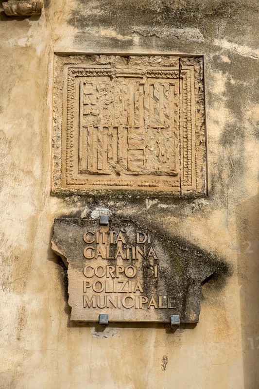 Weathered stone slab on a wall with an ancient inscription in Italian, Galatina, Apulia, Italy