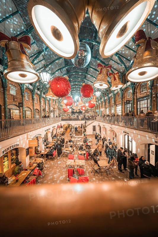View of a decorated shopping mall with big golden bells and red balls on the ceiling, AppleMarket, London, United Kingdom