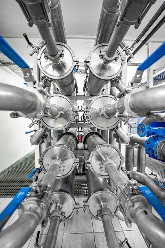 Symmetrical arrangement of metal pipes and valves in an industrial environment, ENCW Netze Calw waterworks, Calw, Black Forest, Germany