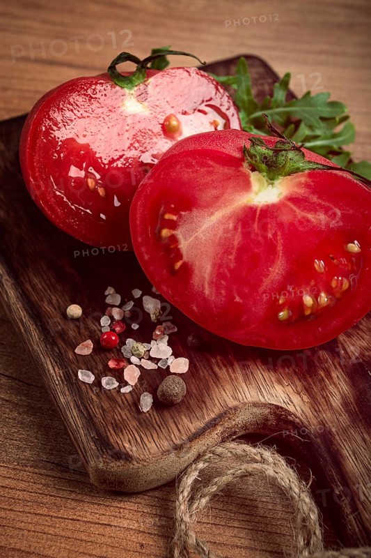 Sliced tomato, on a wooden chopping board, food background, no people