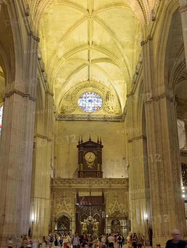 Gothic interior of a cathedral with high ceiling, stained glass window and organ, Seville, Andalusia, Spain