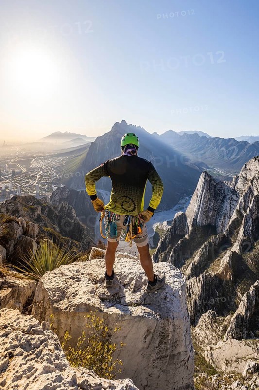 A man pauses on a rocky ledge in Eagleâ€™s Nest, Monterrey, Mexico, after a session of mountaineering and rappelling. The stunning landscape stretches behind him