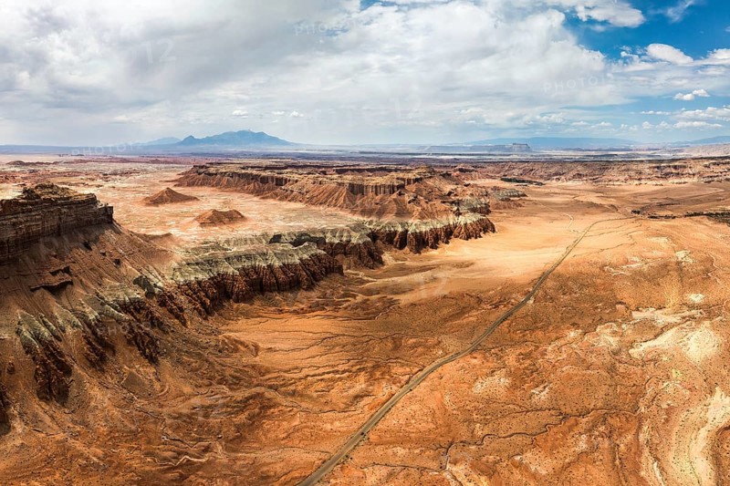 An expansive aerial shot capturing the rugged and unique terrain of Goblin Valley State Park in Utah, showcasing striking geological formations and sweeping desert vistas