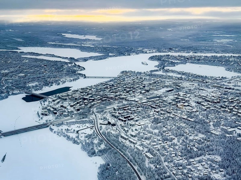 View of the snowy town of Rovaniemi with the Kemijoki river, in winter, aerial view, Finland