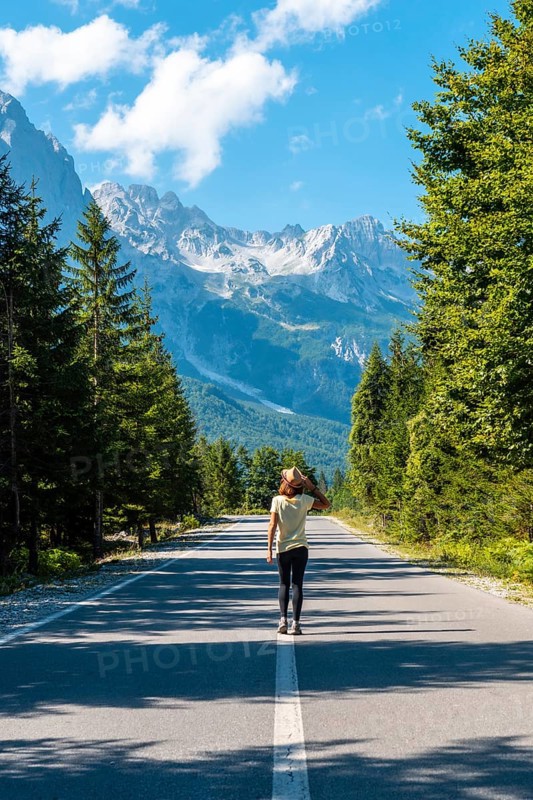 A young girl walking on the road in the Valbona valley, Theth national park, Albanian Alps, Valbona Albania
