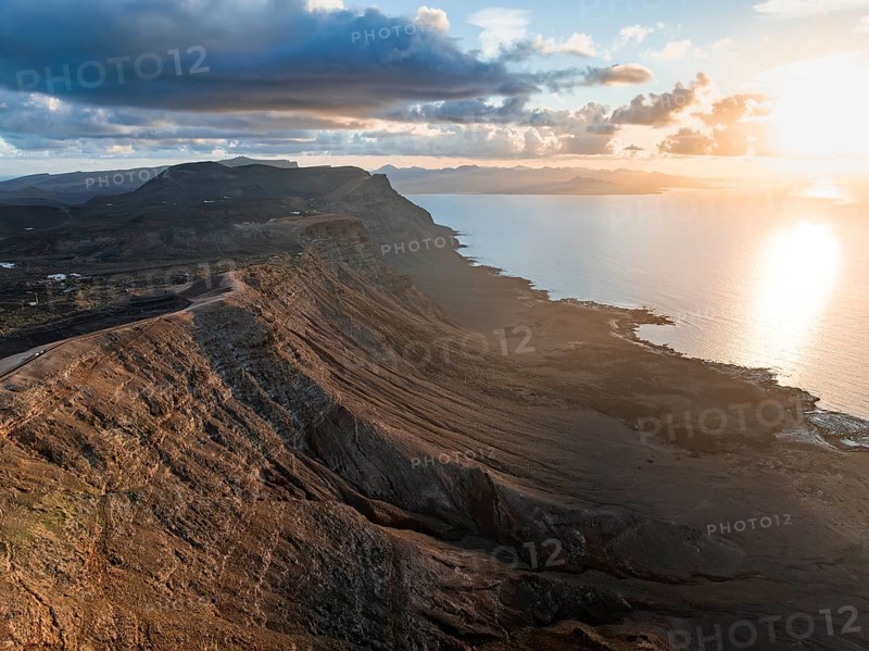 Cliffs by the sea in evening light, steep cliffs on the coast near the Mirador del Porrito, aerial view, at sunset, Lanzarote, Canary Islands, Spain