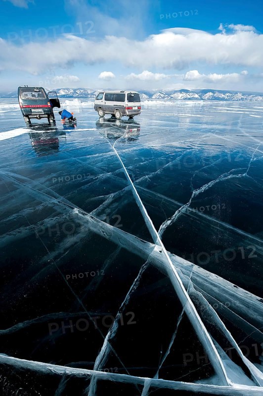 Cars on ice, Lake Baikal, Olkhon Island, Pribaikalsky National Park, Irkutsk Province, Siberia, Russia