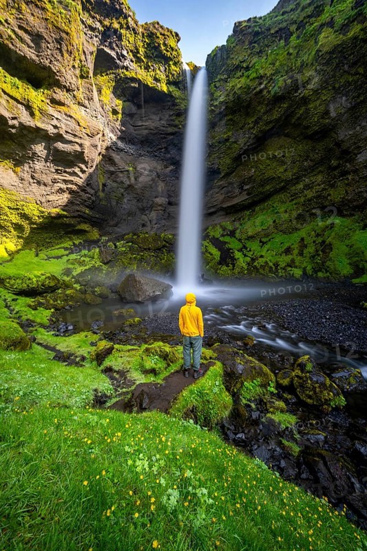 Tourist at Kvernufoss waterfall, in summer when the weather is nice, gorge and river, long exposure, Skogar, Sudurland, South Iceland, Iceland