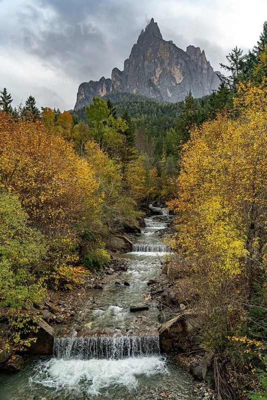 Autumn at the Schwarzgriesbach stream and the Schlern mountain in Seis am Schlern, South Tyrol, Italy