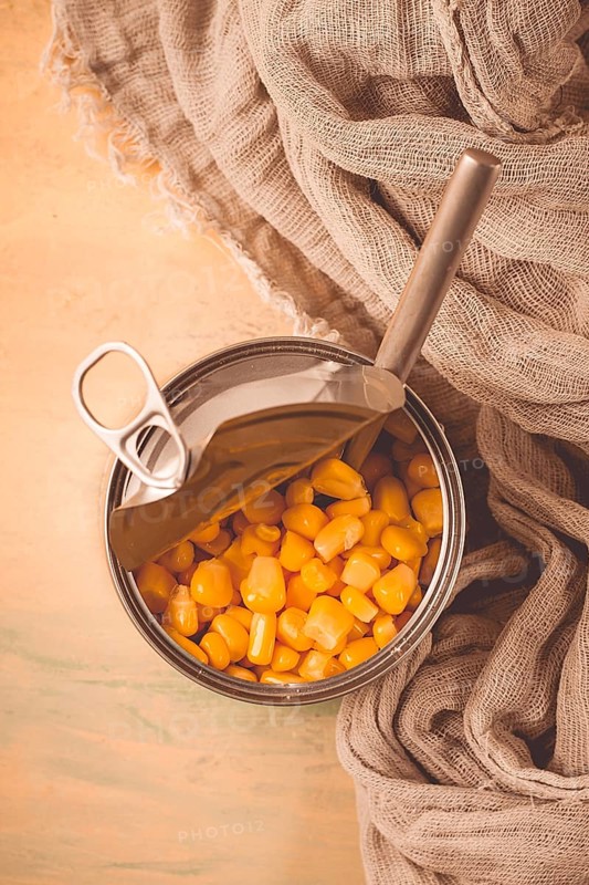 Open tin can, with corn, top view, selective focus, no people, close-up