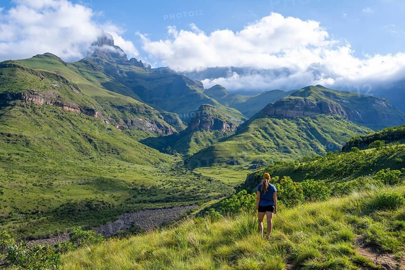 Young female hiker between mountains, Drakensberg National Park, KwaZulu Natal, South Africa