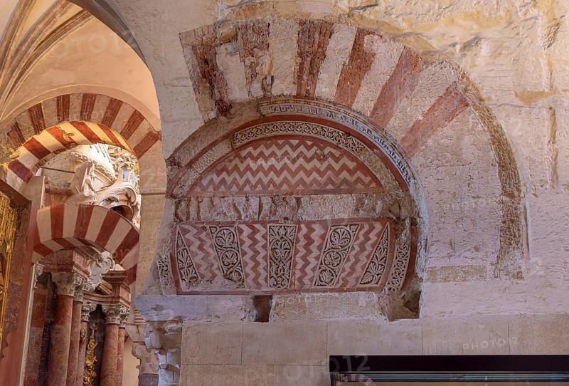 Detailed arched structure with red and white patterns on a stone wall, Cathedral Mosque of Córdoba (Mezquita-Catedral), Cordoba, Andalusia, Spain