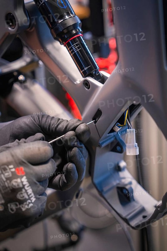 Cables being laid in a bicycle frame, hands with gloves working on it, Waldbike Manufaktur, bicycle workshop, Calw, district of Calw, Black Forest, Germany