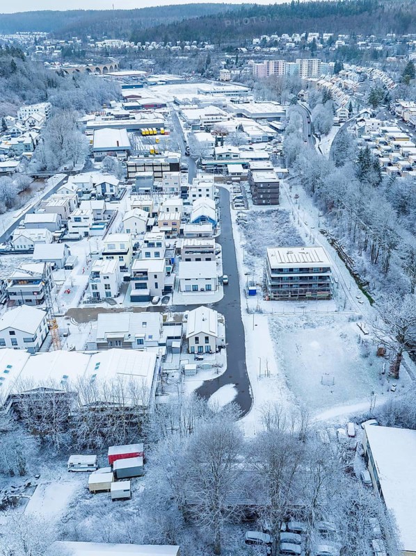 Overview of a snowy cityscape with residential areas and trees, Nagold, Black Forest, Germany