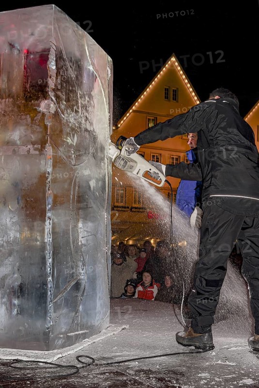An ice sculpture is being created: ice carving street action as part of the long shopping night in the city center of Reutlingen, Baden-Württemberg, Germany, for editorial use only