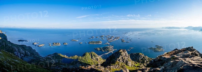 Panorama, view of the sea with numerous small rocky islands with houses, at the summit of Festvågtind, view of Henningsvær, Vågan, Lofoten, Nordland, Norway