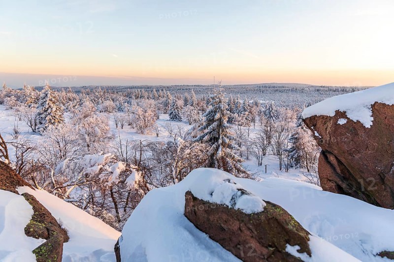 View from Großer Lugstein of the winter landscape with snow-covered trees and branches covered with hoarfrost on the Ore Mountains Ridge at sunset, Zinnwald-Georgenfeld, Altenberg, Eastern Ore Mountains, Saxony, Germany