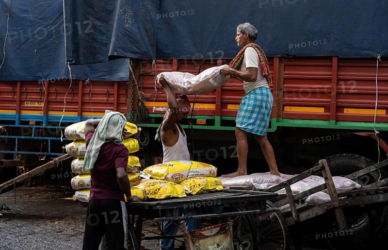 GUWAHATI, INDIA - MAY 1: Labourers carries goods in a wholesale market, in Guwahati, India, on May 1, 2025. May Day or Workers Day is a global holiday celebrated on May 1st to honor workers and their contributions