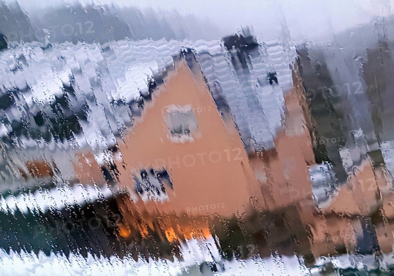 Continuous sleet on a window pane with an unclear view of a house in winter, Witten, North Rhine-Westphalia, Germany