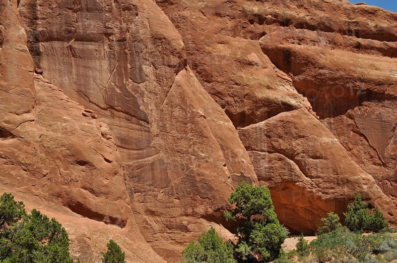 Impressive sandstone walls in the desert with few plants on the ground, Arches National Park, Utah, USA